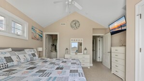 A bedroom with a large bed, a ceiling fan, a clock, a TV, and a dresser. - 3-bedroom condo in delightful Ocean City with WiFi, AC (Ocean City)