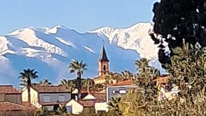 A mountain landscape with a church and residential buildings.