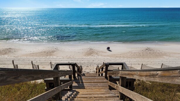 A wooden boardwalk leading to a beach with a wheelchair accessible path. - Sand Cliffs 108: Steps to beach & pool access + Free Attraction Tickets! (Seacrest Beach)
