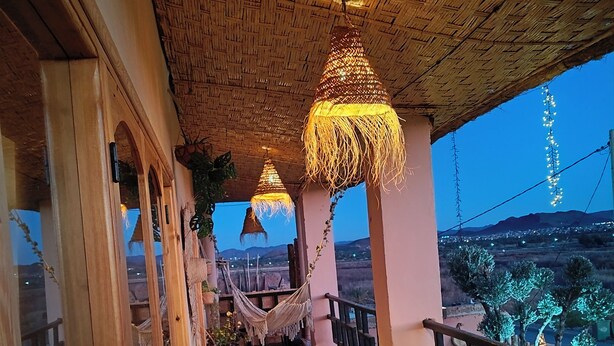 A wooden staircase leading to a balcony with hanging lamps and a view of the landscape. - Villa Calm, Panoramic View of the Lake and Mountains, Ouarzazate Center (Ouarzazate)