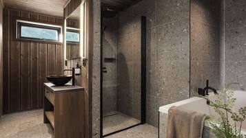 Un baño moderno con tocador de madera, bañera independiente y ducha a ras de suelo.