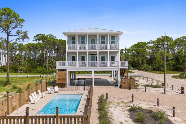 Exterior Facing the Gulf with Pool and Driveway