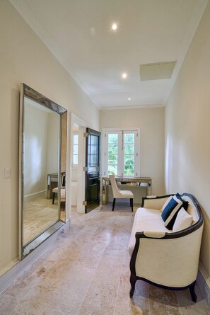 A room with a large mirror, a desk, a chair, and a sofa. - Luxurious Ocean and Golf View Villa staffed with Private Chef, Butler and Maid! (Punta Cana)