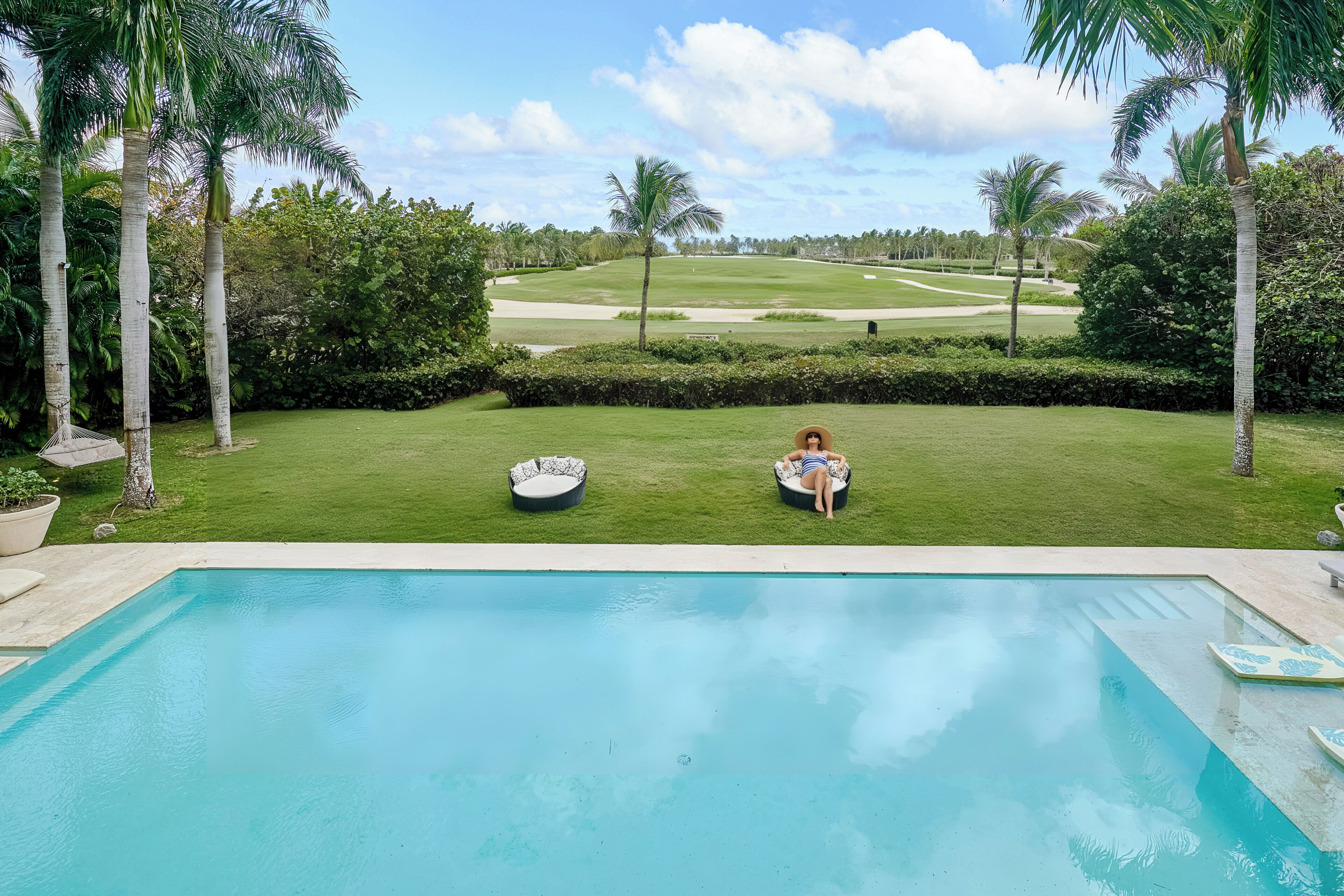 Piscina com vista para um campo de golfe.