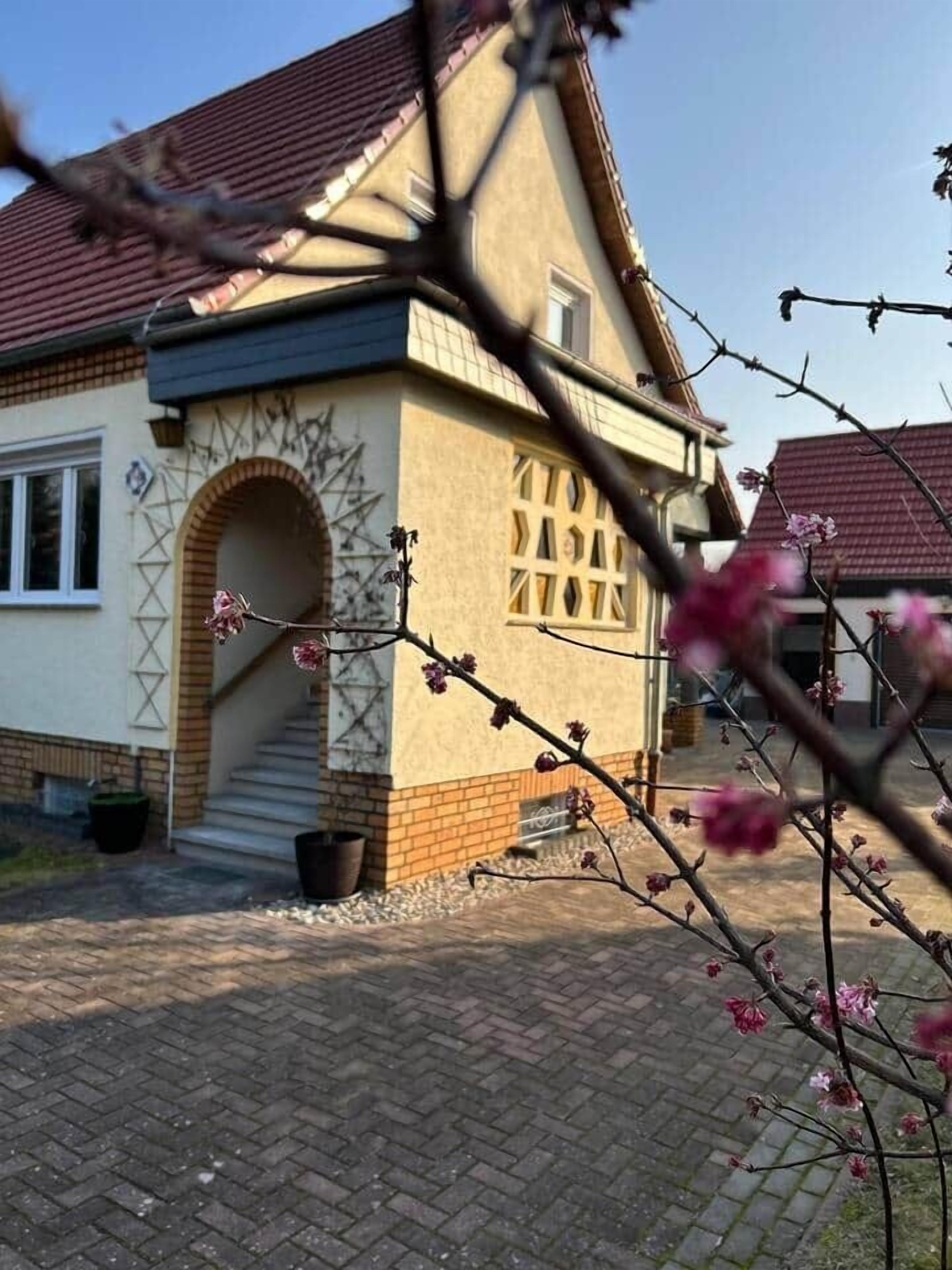 A building with a brick facade, an arched entrance, and a tiled roof.