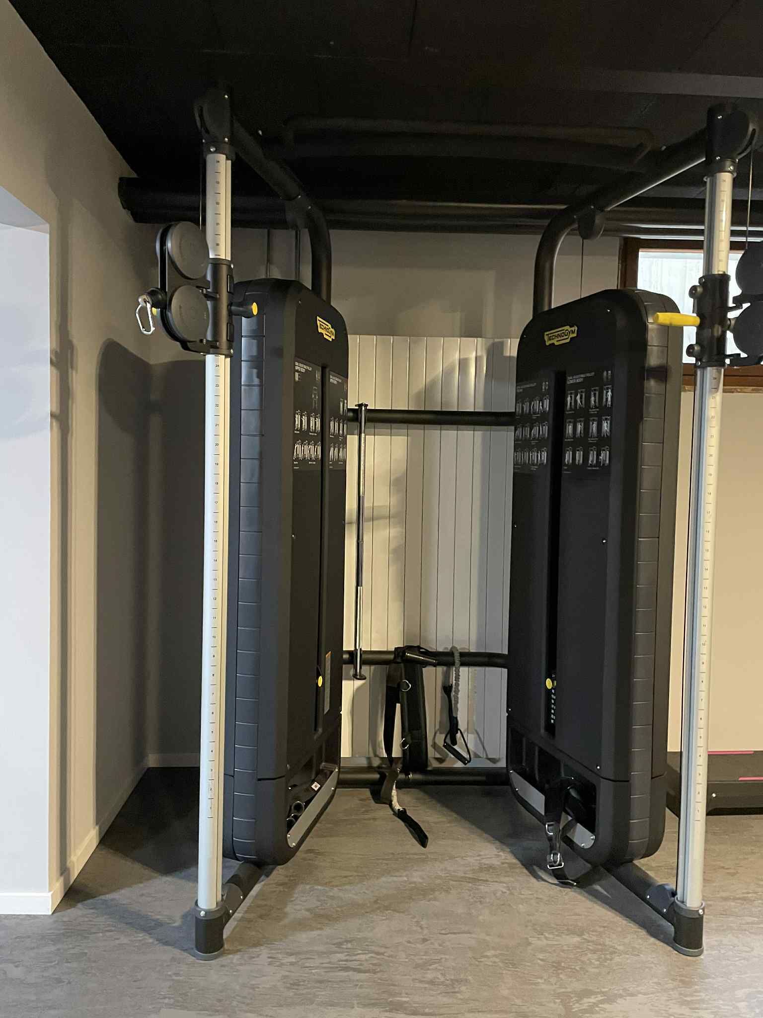 A gym with weightlifting equipment, including squat racks and benches.