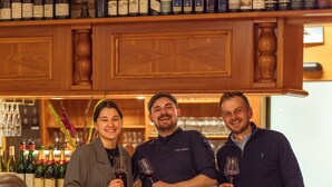 A bar area with wooden cabinets and wine bottles. - Hotel Goldener Engel (Ihringen)