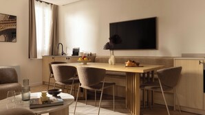 A modern dining area with a wooden table, four chairs, and a large window with curtains. - Cosy Apat With AC -3br- 8P- Canal Saint-martin (Paris)