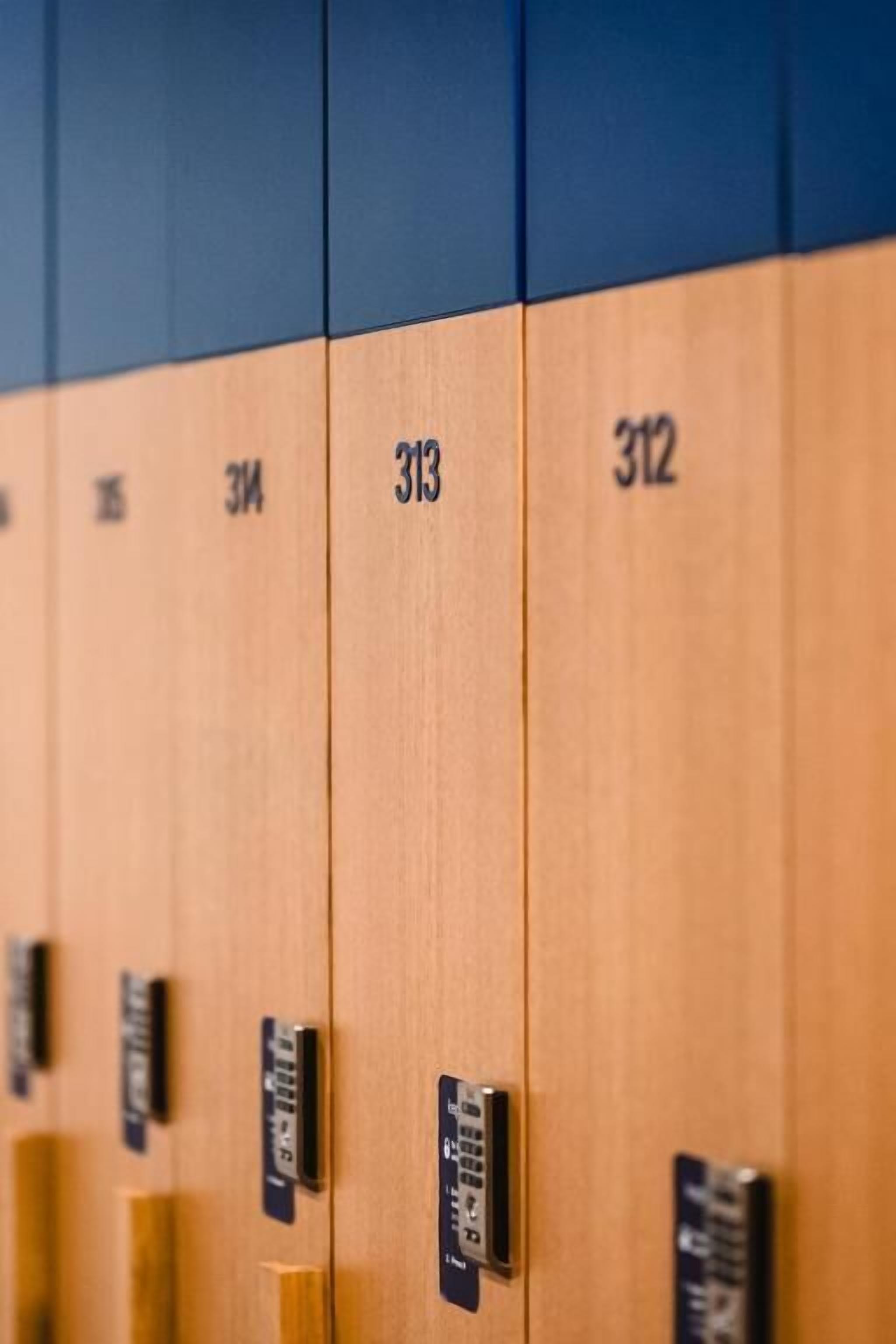 A row of wooden lockers with numbers 313 and 312 visible.