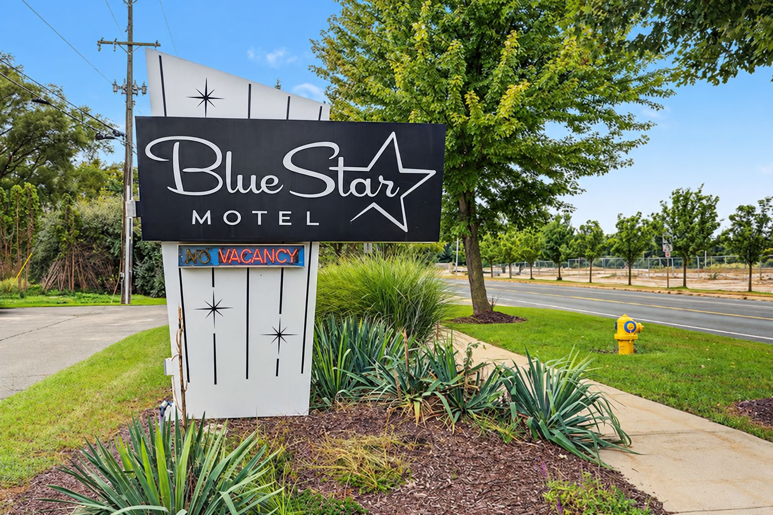 A Blue Star Motel sign with a 'NO VACANCY' notice.