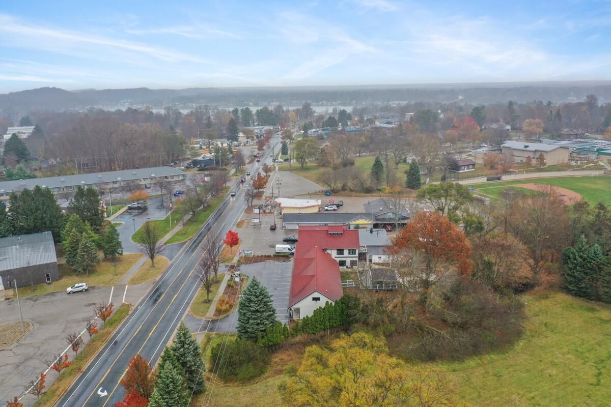An aerial view of a campus with multiple buildings, roads, and surrounding greenery.