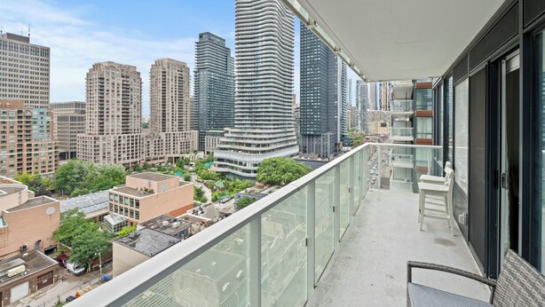 A high-rise building with a modern architectural design, featuring a curved facade and multiple balconies.