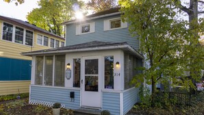 A two-story building with a light blue exterior, a white front door, and a small porch area. - 314 E. 3rd in Lakeside (Lakeside)