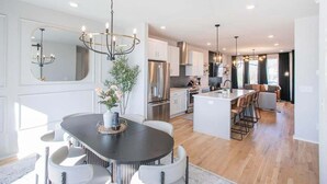 A modern kitchen with a central island, stainless steel appliances, and pendant lighting. - 🌇 Nashville Rooftop Retreat - Fire Pit, Skyline Views, Sleeps 12! 🎶 (Nashville)