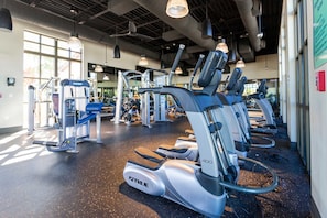 A gym with treadmills, weight machines, and exercise equipment. - Amazing 6bed Home in Solara Fun for All (Kissimmee)