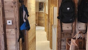 A wooden hallway with a coat rack, a black backpack, and a shelf with a bag. - 100% RENOVATED FAMILY CHALET with view! (Arvieux)