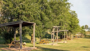 A park with picnic tables and wooden shelters. - Black Hills Station  (Piedmont)