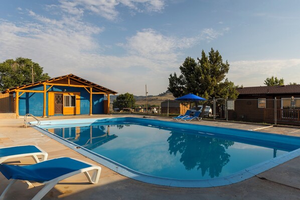 Seasonal outdoor pool, open 8:00 AM to 9:00 PM, pool umbrellas