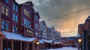 A snow-covered street lined with buildings, some with visible signage and awnings. - Ski-In/Out Summit Watch Resort+Amenities. 2BR (Park City)