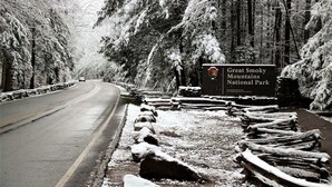 A road leading to Great Smoky Mountains National Park with a signboard and snow-covered trees. - Gatlinburg, Charming Cabin Hearth of Nature With Pool Table, Fireplace, Hot Tub (Sevierville)