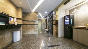 A modern hotel lobby with a reception desk, a self-check-in kiosk, and a seating area. - Hotel Azit - Sinsigaji (Jeonju)