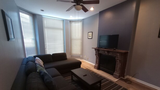 A modern living room with a sectional sofa, a fireplace, and a television. - Beautiful 2 Bedroom located in a Unique Private Park. Near Beaches Near Downtown (Chicago)