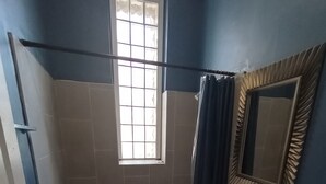 A bathroom with a bathtub, a sink, a toilet, a window, and a mirror. - Beautiful 2 Bedroom located in a Unique Private Park. Near Beaches Near Downtown (Chicago)