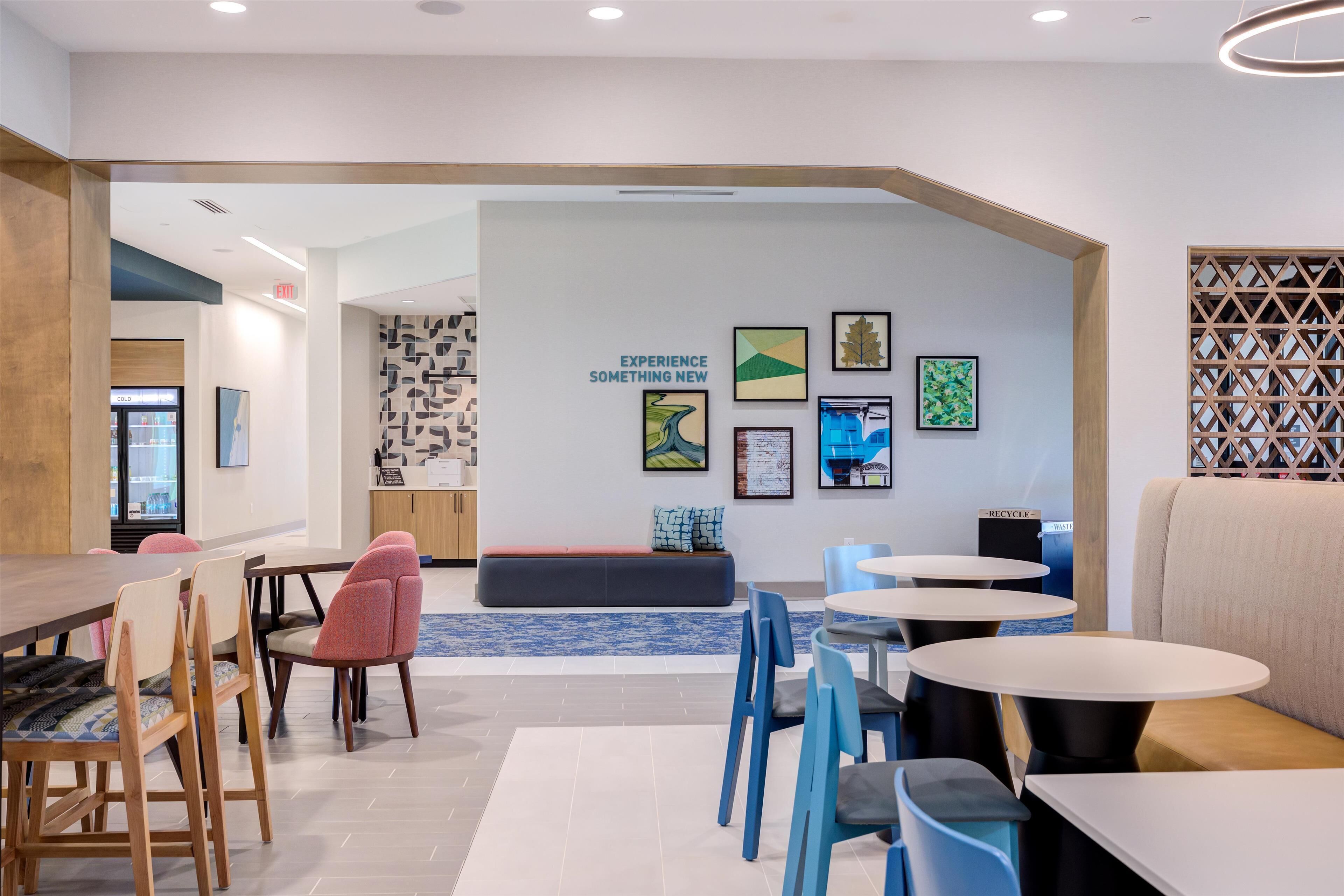A modern interior with a dining area, seating, and artwork on the walls.