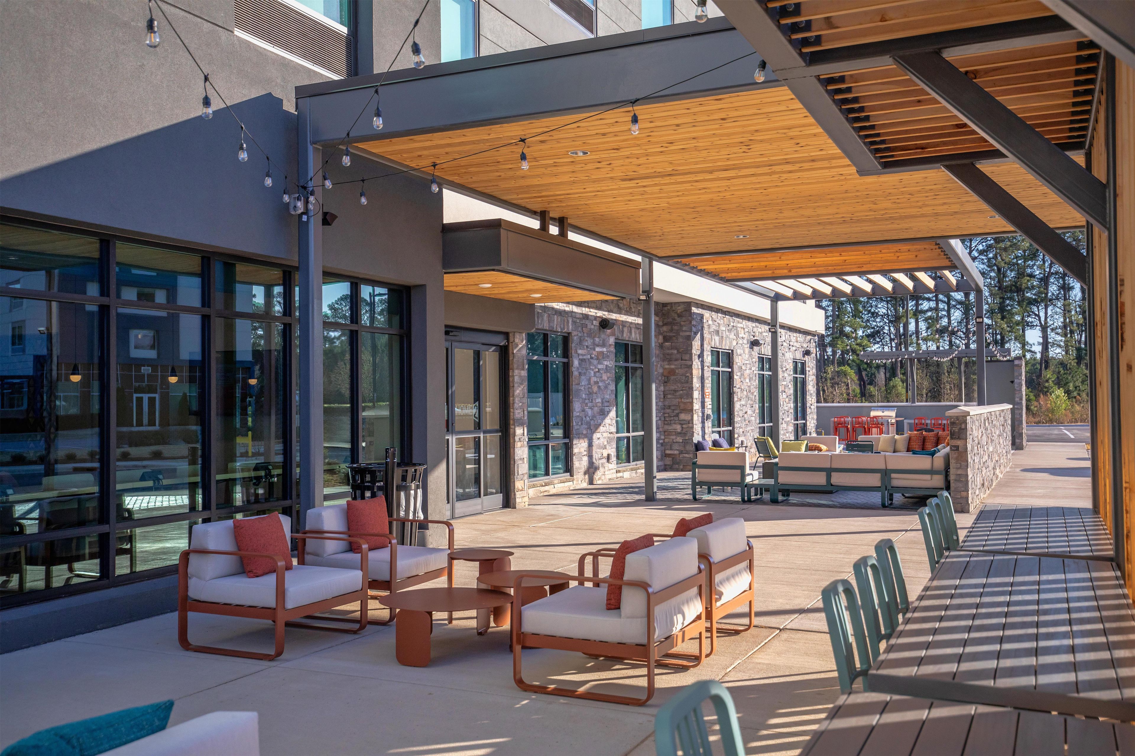 An outdoor patio area with seating arrangements and a view of the surrounding buildings.