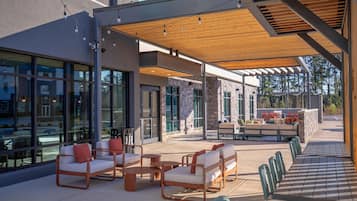 An outdoor patio area with seating arrangements and a view of the surrounding buildings.