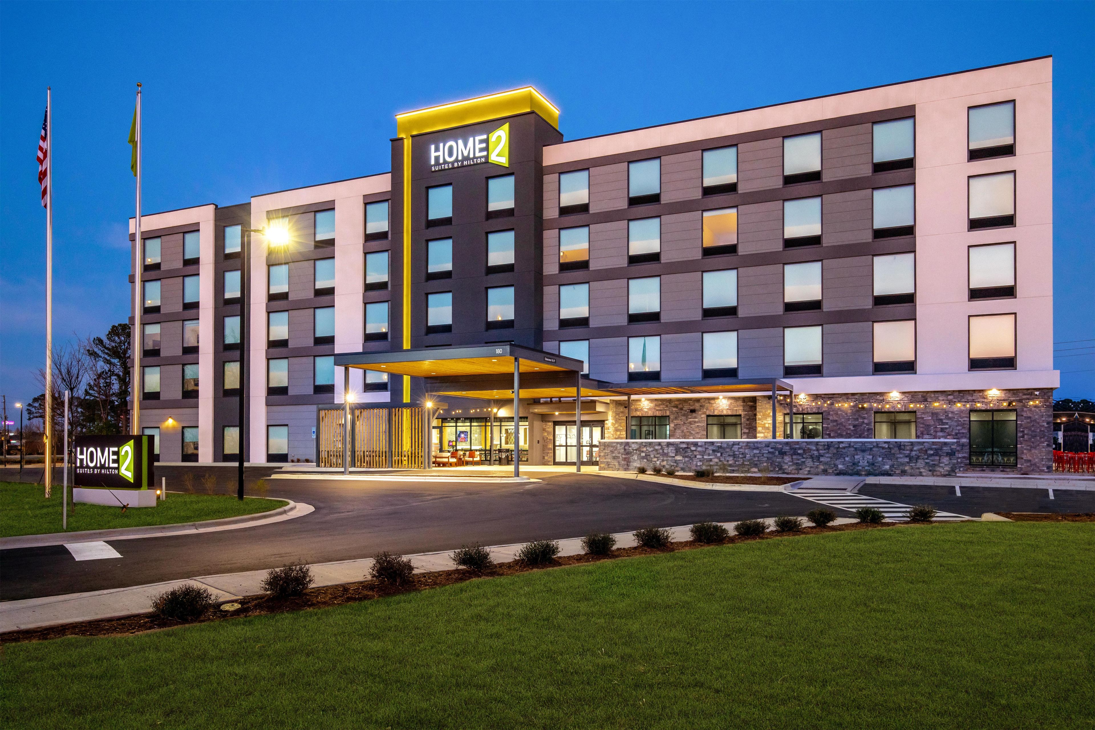 A multi-story hotel with a prominent entrance and a well-lit facade.