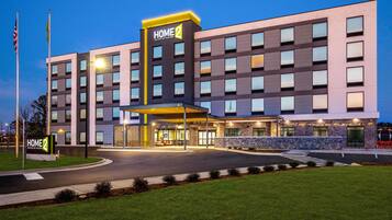 A multi-story hotel with a prominent entrance and a well-lit facade.