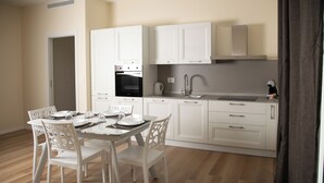A modern kitchen with white cabinetry, a built-in oven, and a sink. - Dimora Amelia Apartment 2, spacious apartment tastefully finished. (Bitonto)