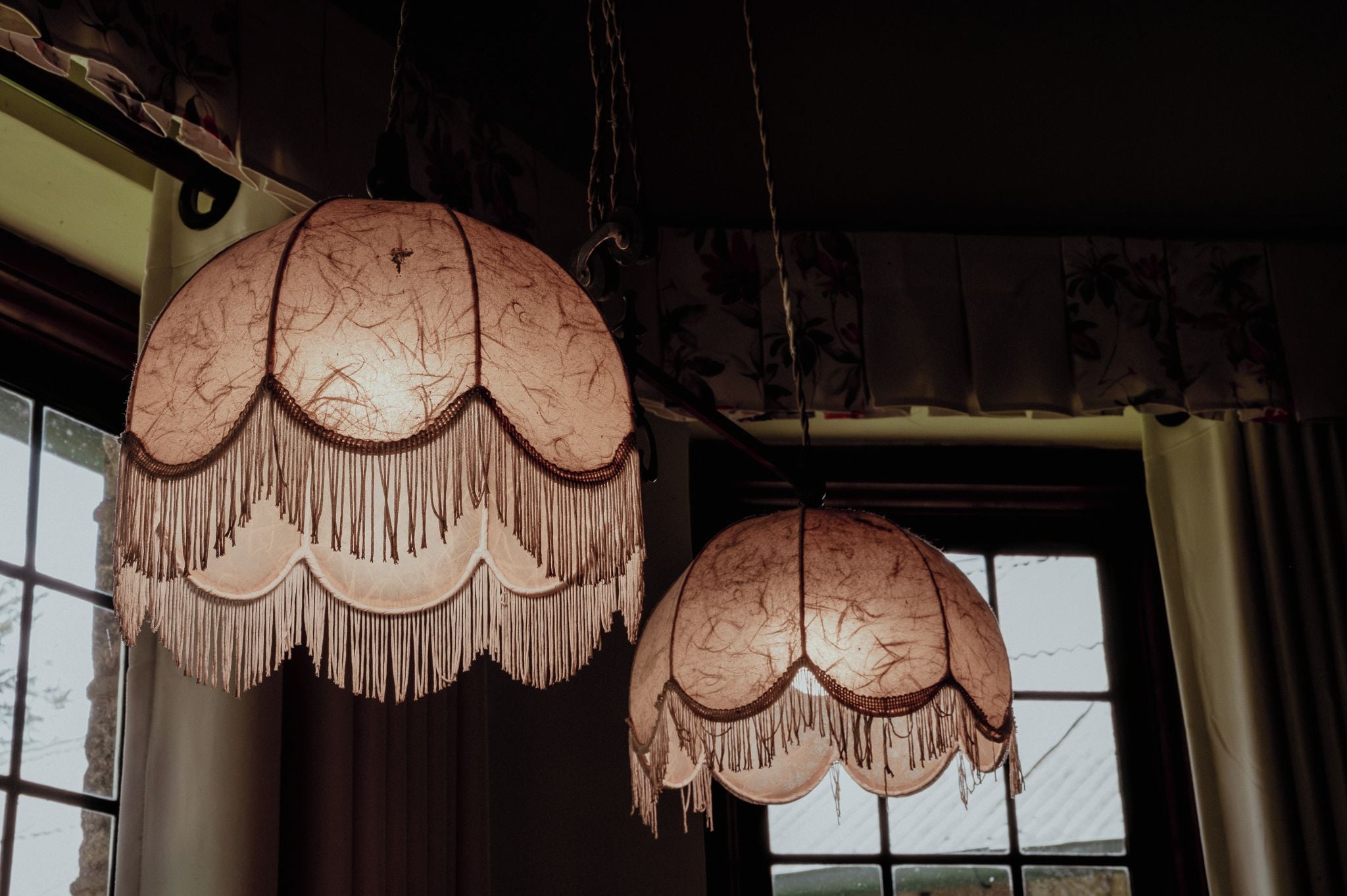 Two large, ornate lamps with fringed shades hanging from the ceiling.