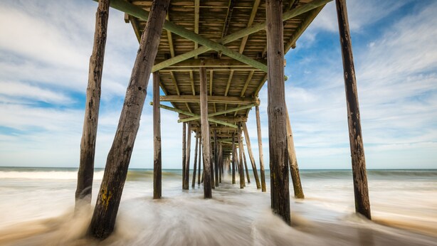 A wooden pier extending into the sea with a clear sky above. - 4BR All Ensuite Baths + Bonus Living Area + Hot Tub + Pet-Friendly + Corolla Lt (Corolla)