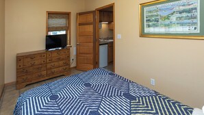 A bedroom with a bed, dresser, and a framed map on the wall. - A Suite Place .5 mi from Beach (Michigan City)