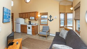 A compact living space with a kitchenette, a dining area, and a seating area with a view. - A Suite Place .5 mi from Beach (Michigan City)