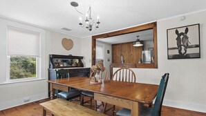 A dining area with a wooden table, chairs, a bench, a chandelier, and a framed picture on the wall. - *NEW*Hops House-Sleeps10-8Mi.toCDP&15Mi.toASV (Hartwick)