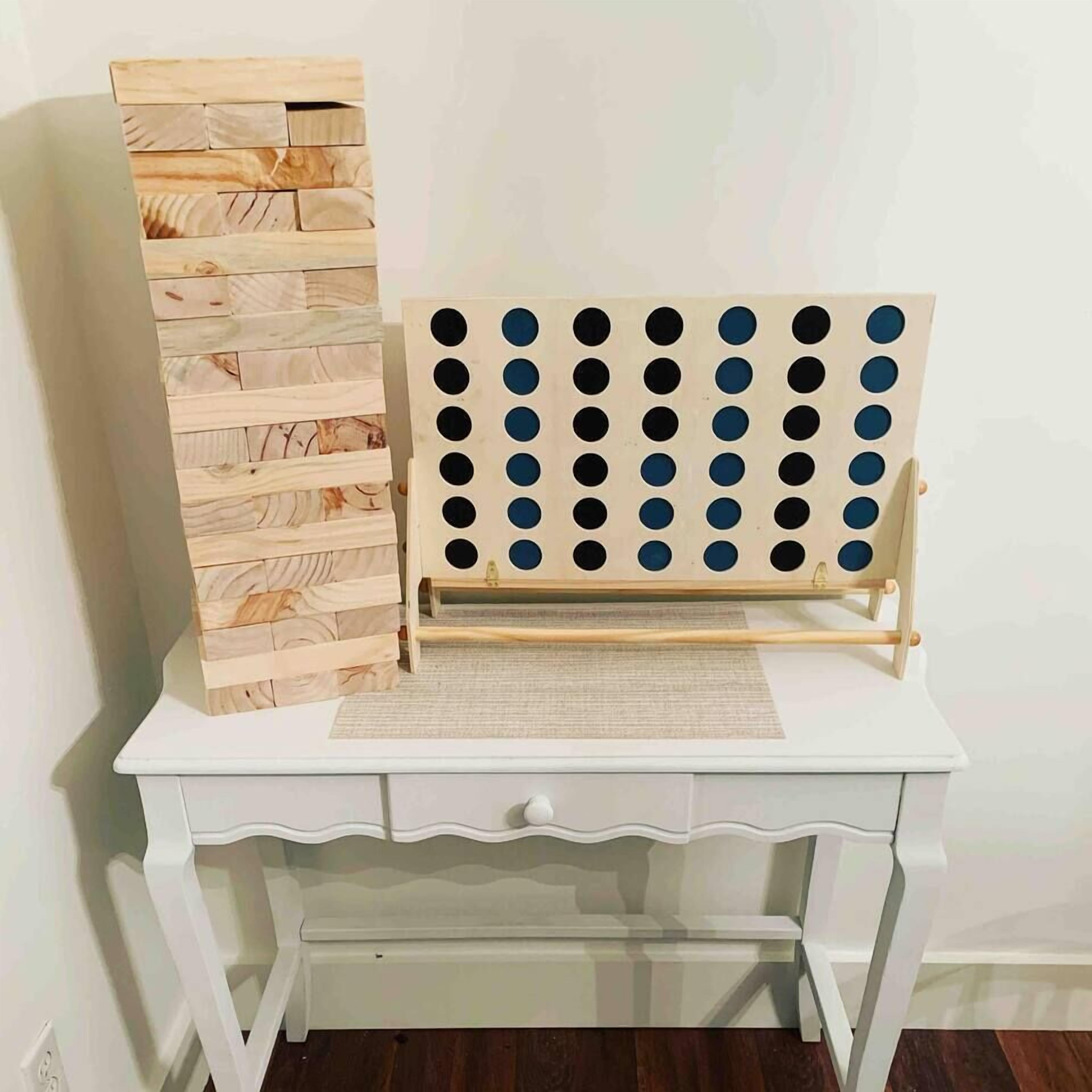 A white desk with a wooden sideboard and a pegboard with circular holes.