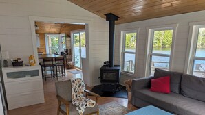 A cozy living room with a sofa, ottoman, and a fireplace. - Come play in the water at this secluded get away.
Observe nature at its best.
 (Little Ridge)