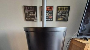 A modern wood-burning stove with a glass front, located in a room with a tiled floor. - Your getaway! Cozy - Nature - Panoramic views! (Lichtenau)