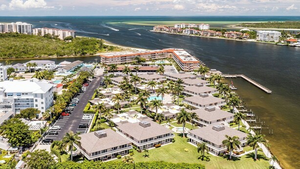 A resort with multiple buildings, a marina, and a beach. - Discover the perfect getaway at Villa De Marco East, (Marco Island)