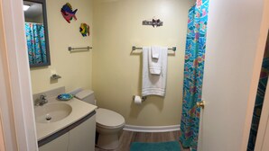 A bathroom with a sink, toilet, and a shower curtain. - Relisted!Ocean Blk, Bay&Ocean view, steps to beach best food & bars 2 Full Baths (Ocean City)