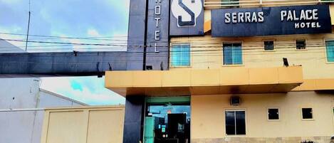 A hotel with a prominent sign reading "SERRAS PALACE HOTEL" and a large 'S' logo.