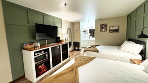 A hotel room with two beds, a TV, a minibar, and a large mirror. - New Room by Silver Dollar City + Shuttle + Pool (Branson)