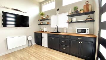 Fridge, microwave, coffee/tea maker, cookware/dishes/utensils