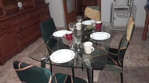 Enjoy meals with family and friends at this dining area, set with a glass table and four comfortable chairs.