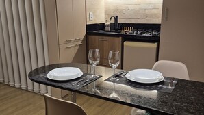 A modern kitchen with a dining area.