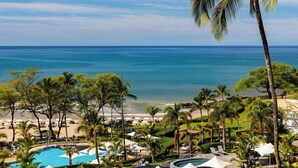 A resort with a pool, beach, and palm trees. - Amaui Island Escape New 4-bedroom home! Free Access to Mauna Kea & Hapuna Beach! (Kamuela)