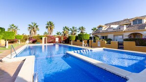 A swimming pool with a clear blue water surface, surrounded by a paved walkway. - 3 bedroom amazing home in Orihuela Costa (Orihuela Costa)